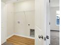 Convenient laundry room features wood floors and white wire shelving at 3959 Wren Dr, Brownsburg, IN 46112