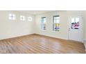 Bright living room with wood floors and large windows and a glass door at 3959 Wren Dr, Brownsburg, IN 46112