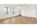 Bright living room with wood floors, staircase and large windows at 3959 Wren Dr, Brownsburg, IN 46112