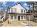 Charming two-story home featuring light-colored siding, gray accents, and a welcoming front porch at 4054 Boulevard Pl, Indianapolis, IN 46208