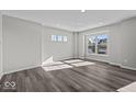 Inviting living room filled with natural light, showcasing hardwood floors and ample space for relaxation and entertainment at 4180 Douro Trl, Westfield, IN 46062