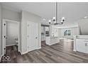 Open-concept living space featuring hardwood floors, neutral walls, modern lighting, and an efficient layout for seamless living at 4180 Douro Trl, Westfield, IN 46062