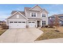 Beautiful two-story home with a spacious driveway and a three-car garage in a residential area at 5646 Mahogany Dr, Noblesville, IN 46062