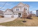 Lovely two-story home featuring a three-car garage and a beautifully landscaped front yard at 5646 Mahogany Dr, Noblesville, IN 46062