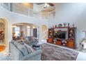 Spacious living room with vaulted ceilings, an entertainment center, and open access to other living spaces at 7823 Beechwood Farms Dr, Avon, IN 46123