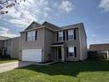 Attractive 2-story home with gray siding, 2-car garage, and a well-maintained front yard on a sunny day at 785 Country Gate Dr, New Whiteland, IN 46184