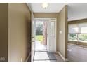 Inviting entryway boasts neutral walls, modern flooring, and a storm door leading to the outdoors at 8212 Nekton Ln, Indianapolis, IN 46236
