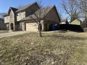 A two-story home featuring a two car garage, set on a beautiful lot with mature trees at 950 Nevelle Ln, Carmel, IN 46032