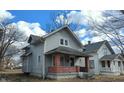 Charming two-story home with a classic design, featuring a covered front porch with brick pillars at 951 N Tuxedo St, Indianapolis, IN 46201