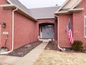 Charming brick home featuring an arched entrance, double doors, and American flag at 9978 Niagara Dr, Fishers, IN 46037