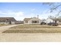 Exterior view of home with beige siding and tidy lawn in a residential neighborhood at 103 S Delawanda Ave, Muncie, IN 47303