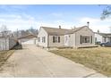 Charming home with an detached garage, long driveway, and manicured lawn at 103 S Delawanda Ave, Muncie, IN 47303