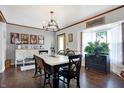 Beautiful dining room with hardwood floors, chandelier, and large windows that create a warm ambiance at 10730 N Park Ave, Carmel, IN 46280