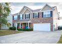 Beautiful two-story home with a brick facade, spacious driveway, two car garage, and manicured landscaping at 1288 Ivory Ct, Greenwood, IN 46143