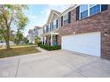Charming two-story home with brick accents, a well-kept lawn, an attached two-car garage, and front porch at 1288 Ivory Ct, Greenwood, IN 46143