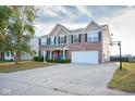 Two-story home featuring brick and vinyl siding, a spacious driveway, attached two-car garage, and basketball hoop at 1288 Ivory Ct, Greenwood, IN 46143