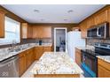 Modern kitchen featuring granite countertops, stainless steel appliances, a center island, and maple cabinetry at 1288 Ivory Ct, Greenwood, IN 46143