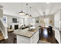 Open-concept kitchen featuring granite countertops, stainless steel appliances, and modern pendant lighting at 1422 Carrollton Ave, Indianapolis, IN 46202
