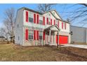 Two-story home boasts great curb appeal with brick and siding exterior, and bright red shutters at 1750 Quiet Haven Cir, Indianapolis, IN 46229