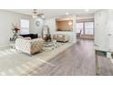 Open living room featuring modern furnishings, beautiful chandeliers, and new vinyl plank flooring at 1750 Quiet Haven Cir, Indianapolis, IN 46229