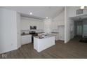 Spacious, modern kitchen featuring white cabinetry, stainless steel appliances, a central island, and hardwood floors at 1841 James Pierce Dr, Shelbyville, IN 46176