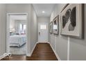 Bright hallway featuring hardwood floors, white trim, and access to a bedroom at 19499 Mcbee Ave, Westfield, IN 46074