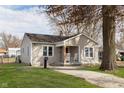 Attractive home featuring a inviting front porch with comfortable seating and a manicured lawn at 218 E Carlisle St, Mooresville, IN 46158