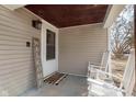 A charming and intimate front porch showcases seating, welcome sign, and warm light fixture at 218 E Carlisle St, Mooresville, IN 46158