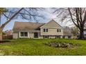 Charming home featuring a well-manicured lawn and a mix of brick and siding exterior elements at 220 Pine Dr, Indianapolis, IN 46260