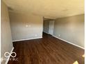 A spacious living room features hardwood floors and neutral paint, providing a blank canvas at 2306 John Glenn Ct, Indianapolis, IN 46229