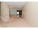 Neutral living area leading to dining space with light blue accent wall and staircase at 2336 Boneset Dr, Plainfield, IN 46168