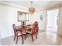 Formal dining room with a chandelier, wood table, chairs, and decorative mirrors at 327 Maxwell Rd, Indianapolis, IN 46217
