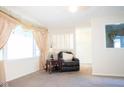 Cozy living room featuring an armchair, side table, and large window providing plenty of natural light at 327 Maxwell Rd, Indianapolis, IN 46217