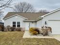 Well-maintained single-story home with attached garage and manicured landscaping at 3408 Village Dr, Anderson, IN 46011