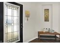 Inviting entryway with decorative glass door, wooden bench, and neutral decor, setting a welcoming tone at 3423 Shadow Bend Dr, Columbus, IN 47201