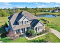 Sprawling home with lush lawn, mature trees and tranquil pond offers scenic views and backyard privacy at 3537 Old Quarry Dr, Zionsville, IN 46077