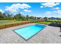 Backyard pool is surrounded by a patio area perfect for entertaining or enjoying a quiet swim at 3537 Old Quarry Dr, Zionsville, IN 46077