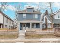 Charming two-story home featuring blue siding, a covered porch, and a well-maintained front yard at 3550 N Illinois St, Indianapolis, IN 46208