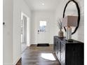 Modern entryway features wood flooring, a decorative mirror, and a stylish console table at 3588 Planck Cir, Danville, IN 46122