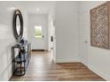 Inviting entryway featuring wood floors, a decorative mirror, and a view of the front door at 3706 Cantebury Dr, Franklin, IN 46131
