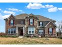 Charming two-story home featuring brick, stone accents, and well-maintained landscaping at 5683 Oakmont Blvd, Bargersville, IN 46106