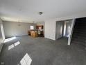 Spacious living room featuring modern gray walls, new carpet, and an open floor plan at 5816 Dollar Forge Dr, Indianapolis, IN 46221