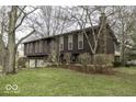 Rear elevation featuring upper and lower windows with a chimney at 615 Shady Creek Dr, Greenwood, IN 46142