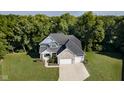 Aerial view of a stunning home with well-maintained landscaping and a spacious driveway at 6208 W Foster Ridge Ln, Pendleton, IN 46064