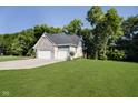 Side view of a beautiful home with a large yard and an attached two-car garage at 6208 W Foster Ridge Ln, Pendleton, IN 46064