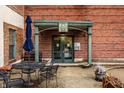 Building entrance framed in green with seating and potted plants on concrete patio at 735 Lexington Ave # 1, Indianapolis, IN 46203