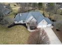 Beautiful aerial view of a brick home with a three-car garage and a spacious driveway at 7472 Windridge Way, Brownsburg, IN 46112
