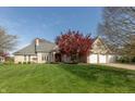Charming brick home featuring a meticulously manicured lawn and vibrant landscaping, creating excellent curb appeal at 7472 Windridge Way, Brownsburg, IN 46112