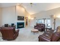 Spacious living room with a fireplace, high ceilings, and large windows at 7472 Windridge Way, Brownsburg, IN 46112