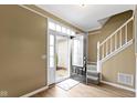 Welcoming entryway featuring wood-look flooring, stairway access, and a door with glass accents at 7591 Meadow Ridge Dr, Fishers, IN 46038